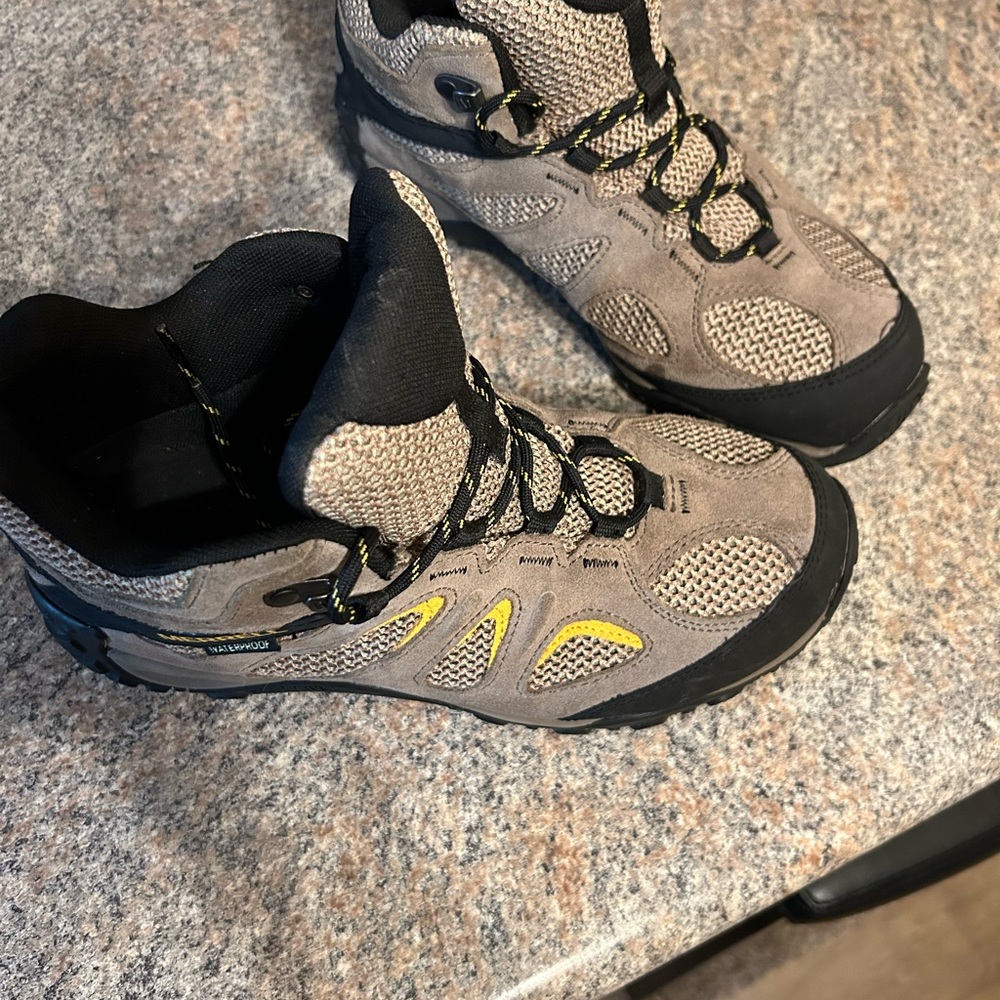 Tan and black men’s Merrill boots, waterproof size 8 1/2 wide